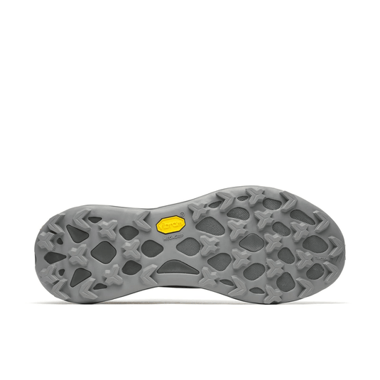 Close-up of a shoe sole with a textured pattern and yellow accent on a white background