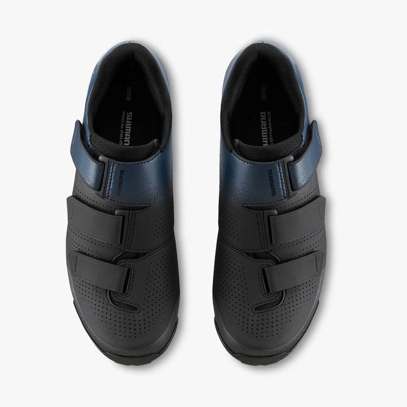 Load image into Gallery viewer, Pair of black cycling shoes with velcro straps on a white background
