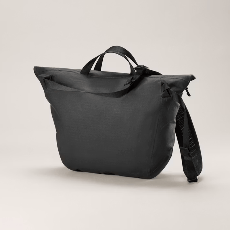 Load image into Gallery viewer, Black backpack on a light beige background

