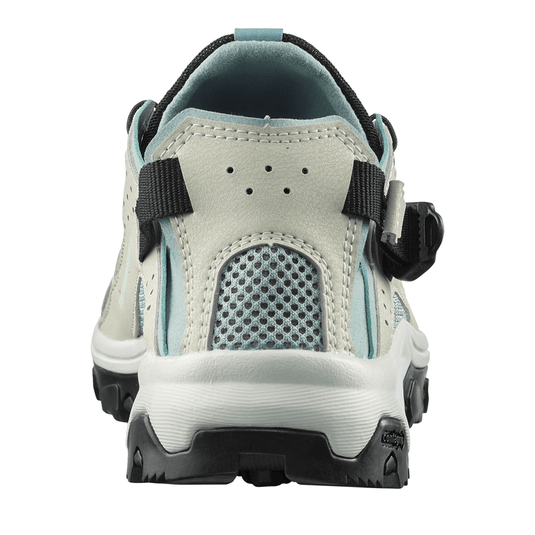 Back view of a light gray sandal with black straps on a white background