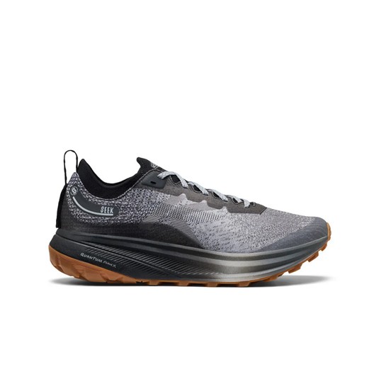 Gray and black running shoe with brown sole on a white background