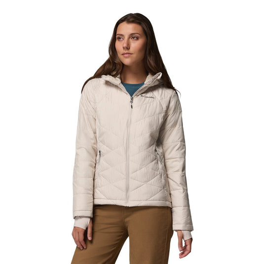 Woman wearing a beige quilted jacket on a white background