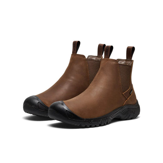 Pair of brown leather boots with black soles on a white background
