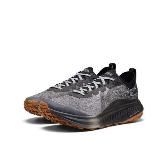 Gray and black running shoes with brown soles on a white background