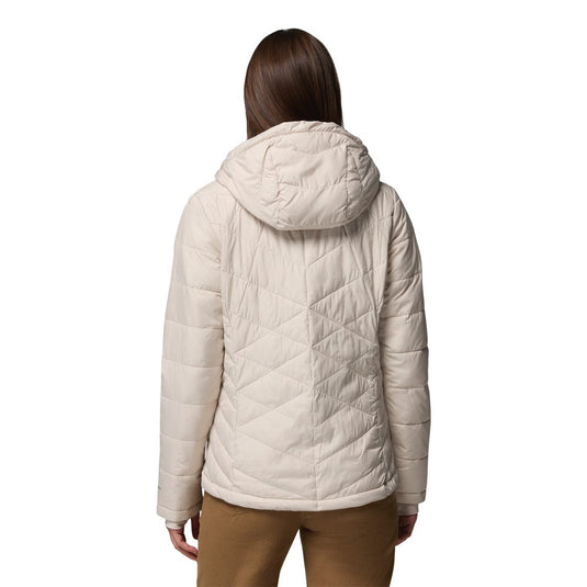 Person wearing a beige quilted jacket on a white background