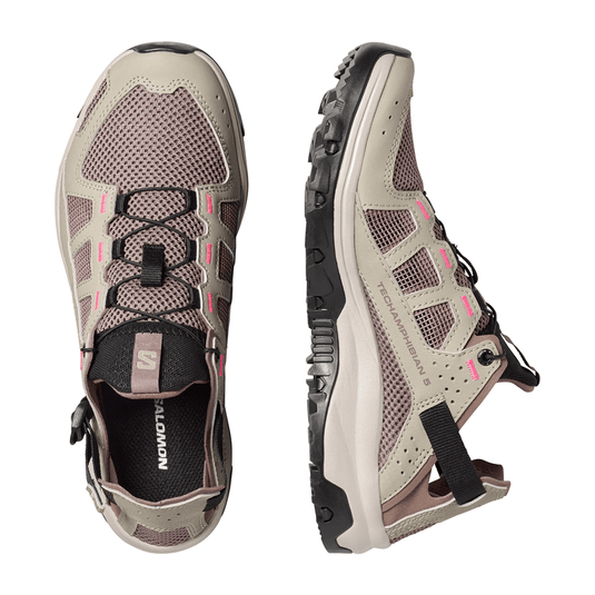 Pair of beige and black hiking shoes on a white background