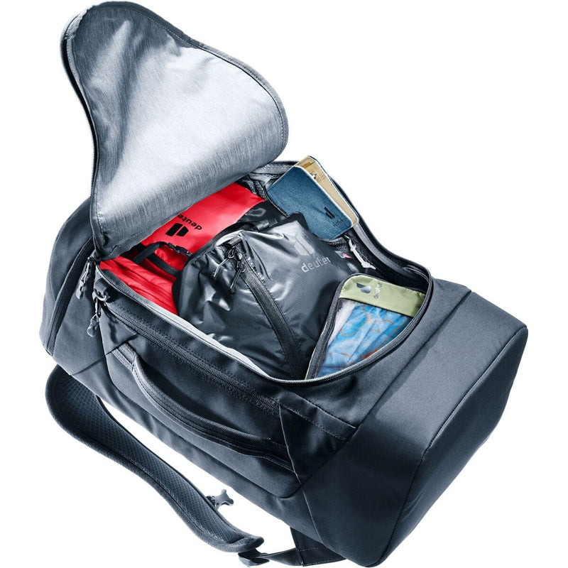 Load image into Gallery viewer, Gray backpack with compartments containing various items on a white background
