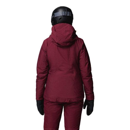 Person wearing a maroon snowsuit with a helmet on a white background