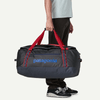 Person holding a Patagonia duffel bag with red straps on a white background
