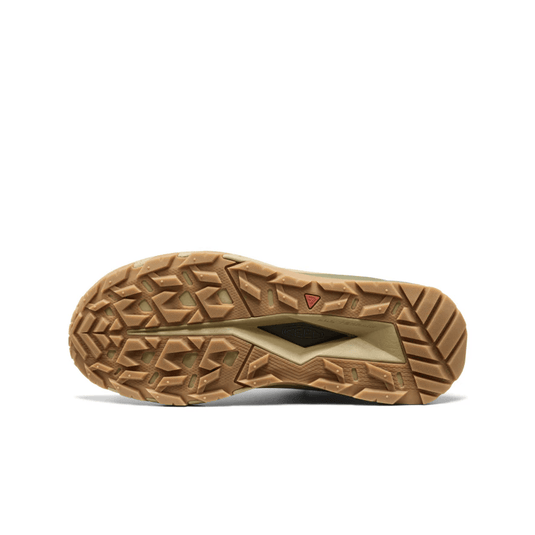 Close-up of a brown shoe sole with tread pattern on a white background
