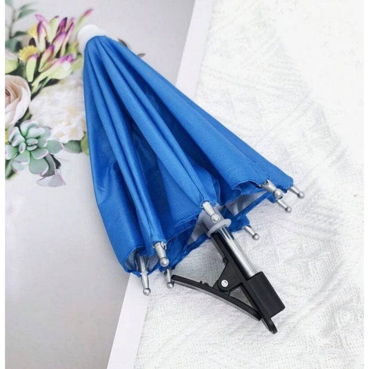 Blue umbrella with metal shaft on a white surface